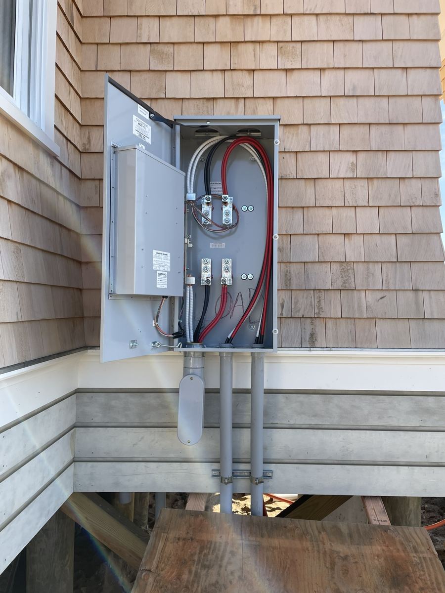 New meter pan and service disconnect on a cedar-shingle house